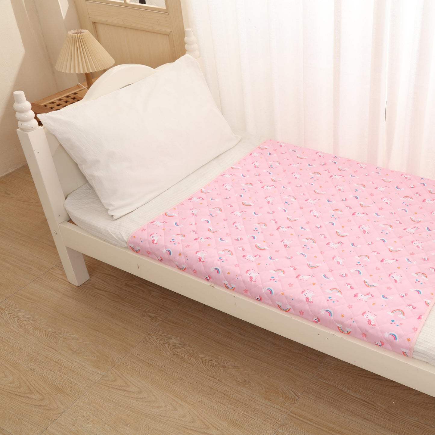 White bed with pink floral mattress cover in a bright room